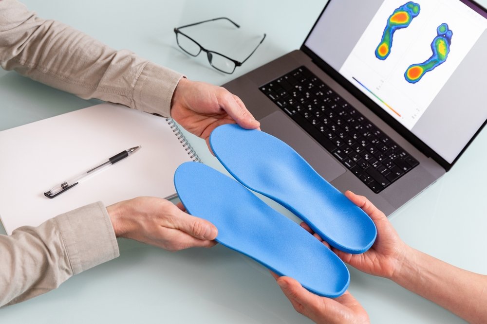 Custom orthotics and a foot pressure scan during a biomechanical assessment in Vancouver
